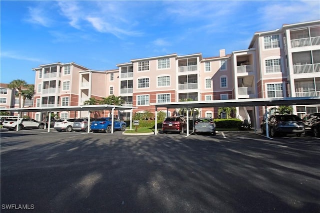 view of building exterior featuring covered parking