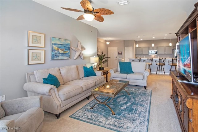 living room with light carpet and ceiling fan