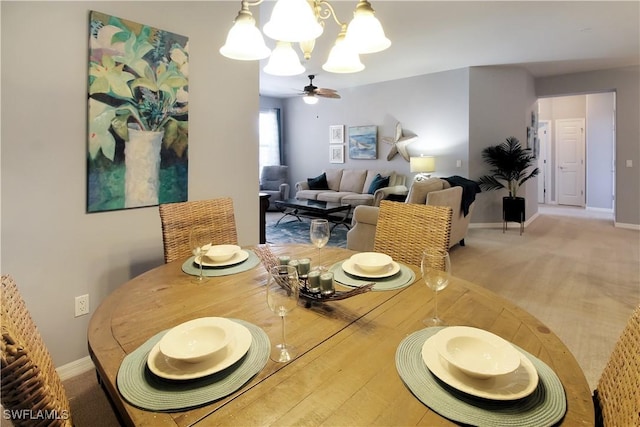 dining area featuring baseboards and a notable chandelier