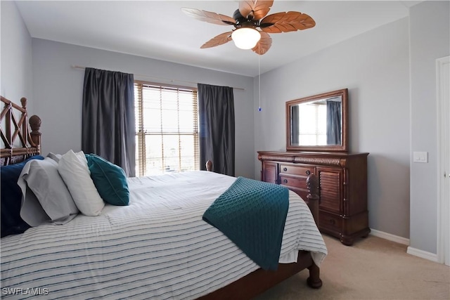 bedroom with light carpet, ceiling fan, and baseboards