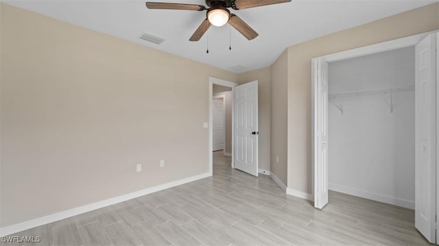 unfurnished bedroom featuring ceiling fan, visible vents, baseboards, a closet, and light wood finished floors