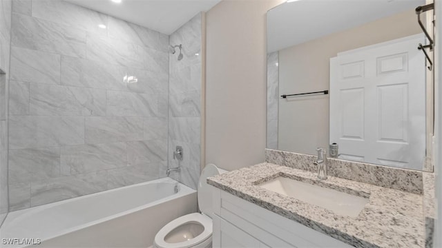 bathroom featuring washtub / shower combination, vanity, and toilet