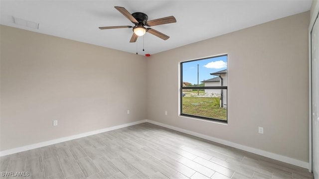 empty room with light wood-type flooring, baseboards, visible vents, and ceiling fan