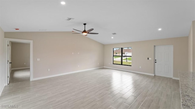 empty room with visible vents, baseboards, ceiling fan, vaulted ceiling, and light wood-style floors