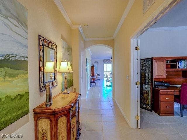 hallway featuring ornamental molding, arched walkways, and light tile patterned floors