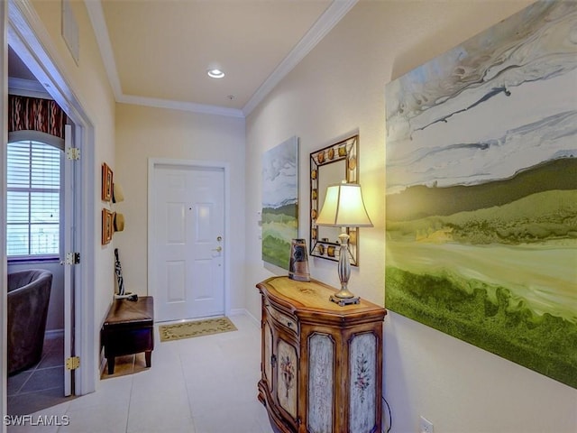 doorway with baseboards, visible vents, and crown molding