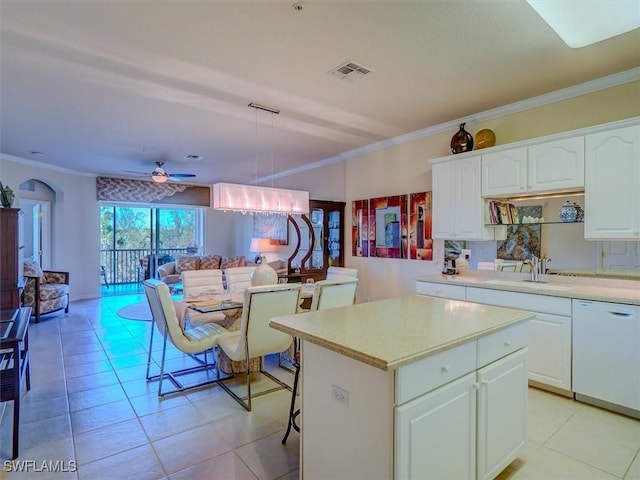 kitchen featuring dishwasher, ornamental molding, a sink, and visible vents