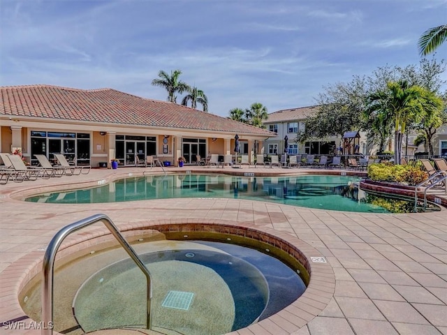 community pool featuring a patio and a community hot tub