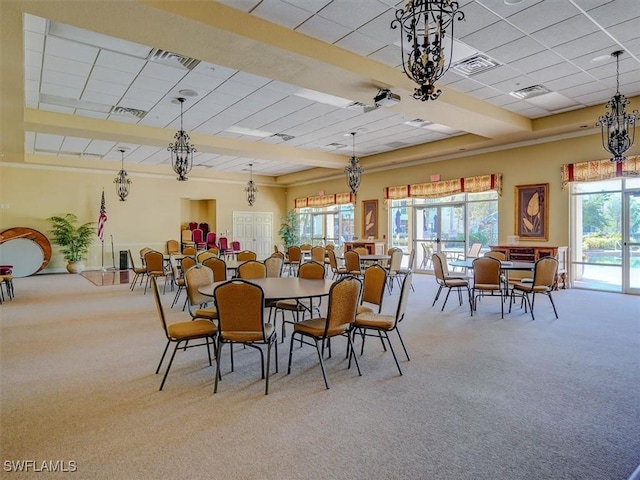 dining room with a healthy amount of sunlight, carpet, and visible vents