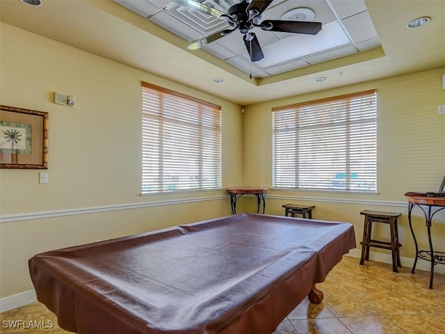 game room featuring a raised ceiling, a healthy amount of sunlight, and billiards