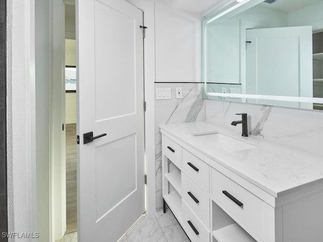 bathroom featuring marble finish floor and vanity