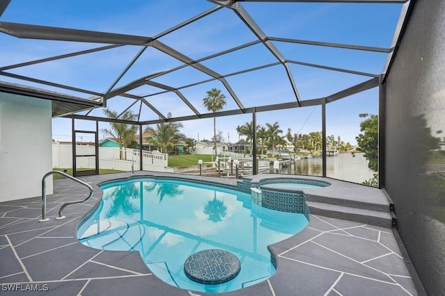 view of swimming pool with glass enclosure, a patio area, fence, and a pool with connected hot tub