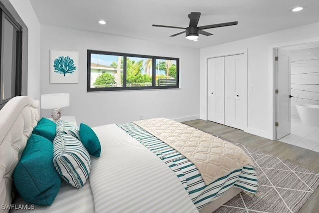 bedroom with a closet, a ceiling fan, wood finished floors, and recessed lighting