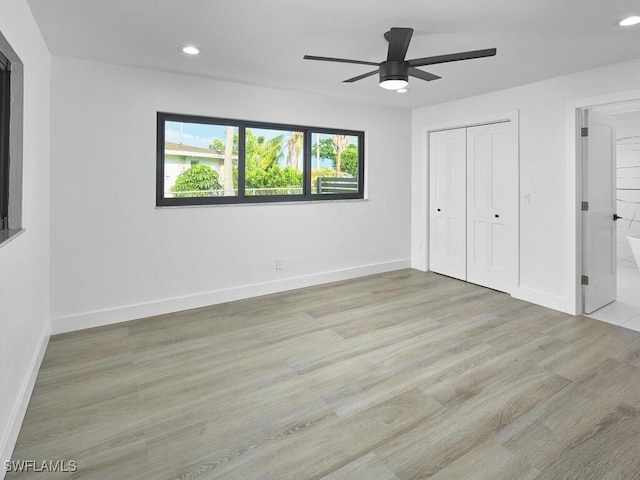 unfurnished bedroom featuring baseboards, wood finished floors, and recessed lighting