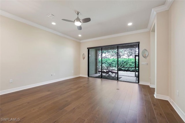 unfurnished room with crown molding, visible vents, dark wood finished floors, and baseboards