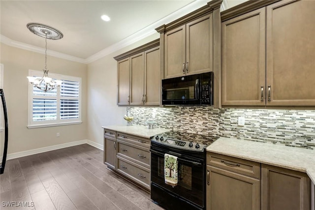 kitchen featuring baseboards, dark wood-style floors, crown molding, black appliances, and backsplash