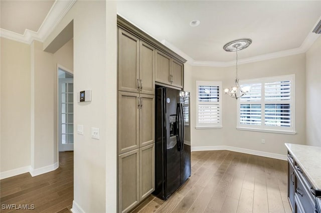 kitchen featuring ornamental molding, black refrigerator with ice dispenser, dark wood-style flooring, and an inviting chandelier