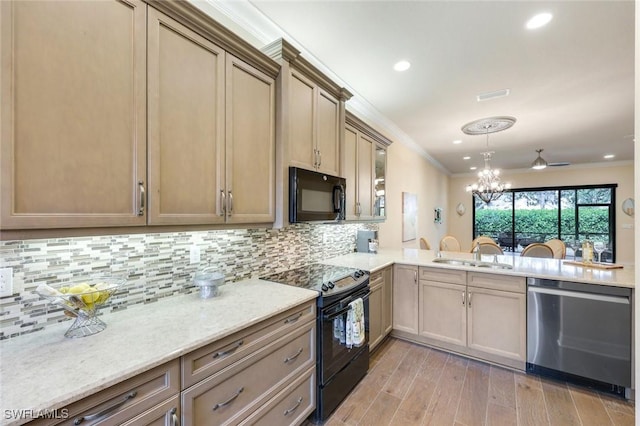 kitchen featuring backsplash, ornamental molding, light wood-style floors, a sink, and black appliances