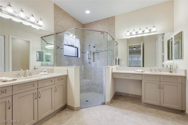 full bath with a stall shower, a sink, and tile patterned floors