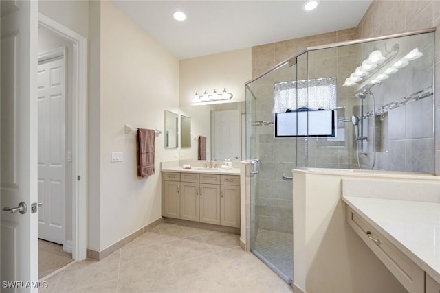 bathroom with baseboards, tile patterned flooring, vanity, a shower stall, and recessed lighting