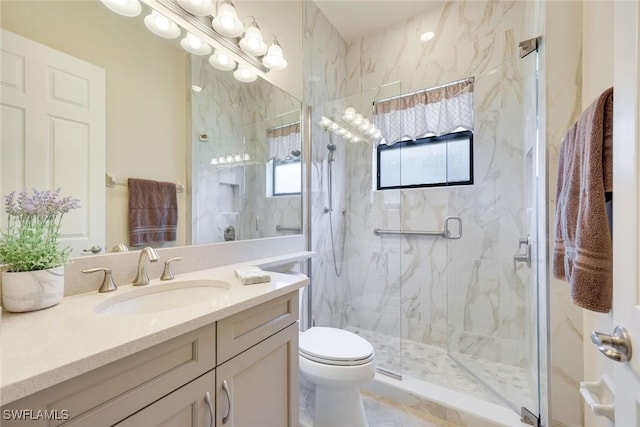 full bath with vanity, a marble finish shower, toilet, and an inviting chandelier