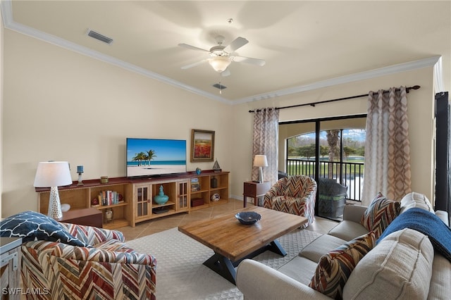 living room featuring a ceiling fan, visible vents, crown molding, and tile patterned floors