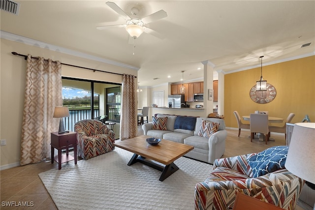 living room featuring light tile patterned floors, baseboards, visible vents, and crown molding