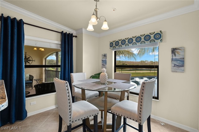 dining area featuring a chandelier, crown molding, baseboards, and light tile patterned floors