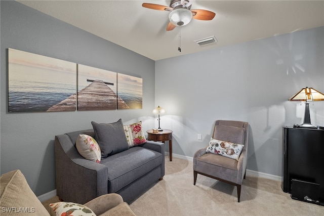 living room featuring ceiling fan, carpet floors, visible vents, and baseboards