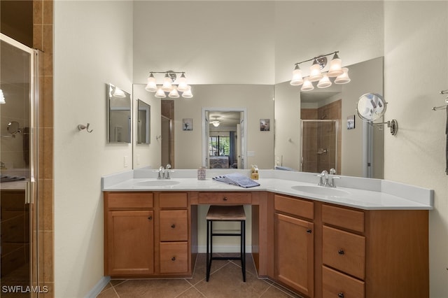 full bath featuring double vanity, tile patterned flooring, a sink, and a shower stall