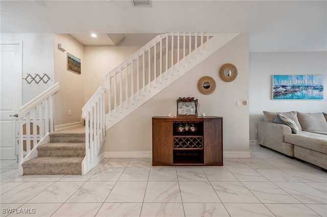 stairs featuring recessed lighting, marble finish floor, visible vents, and baseboards