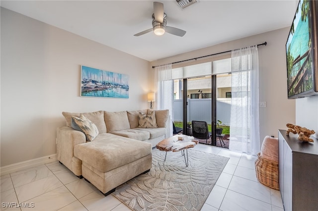 living room featuring a ceiling fan, visible vents, and baseboards