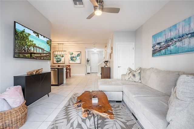 living room featuring marble finish floor, visible vents, and a ceiling fan