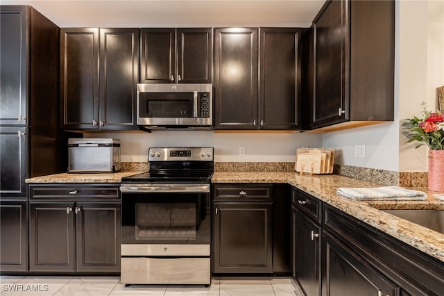 kitchen with light stone counters and stainless steel appliances