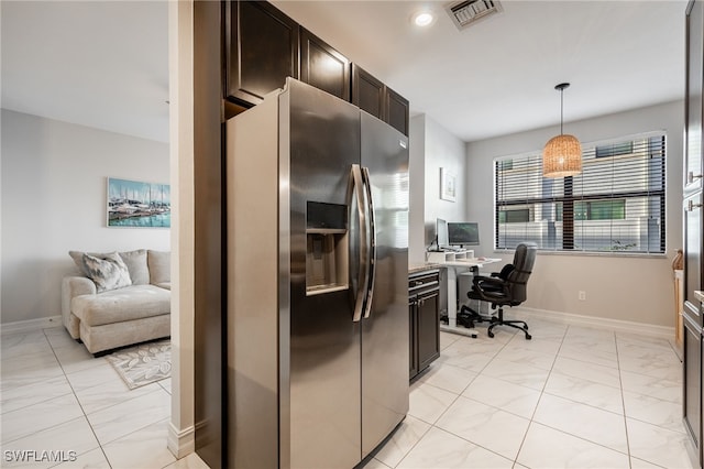 kitchen with dark brown cabinets, stainless steel refrigerator with ice dispenser, visible vents, and baseboards