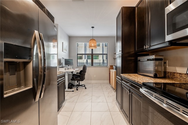 kitchen with light stone counters, marble finish floor, pendant lighting, stainless steel appliances, and baseboards