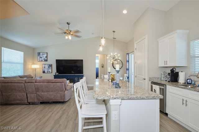 kitchen featuring light wood-type flooring, open floor plan, white cabinets, and dishwasher