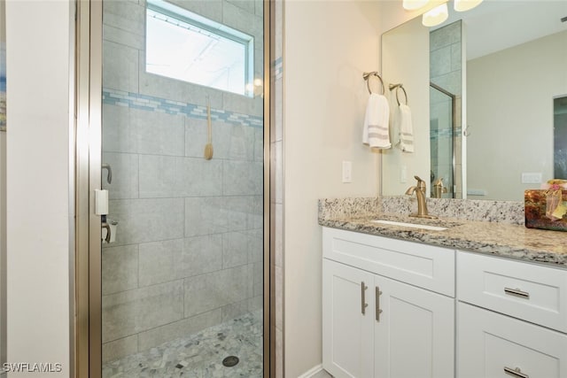 full bath featuring a shower stall and vanity