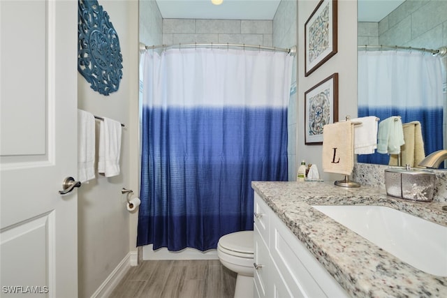 full bath featuring toilet, wood finished floors, vanity, and a shower with curtain