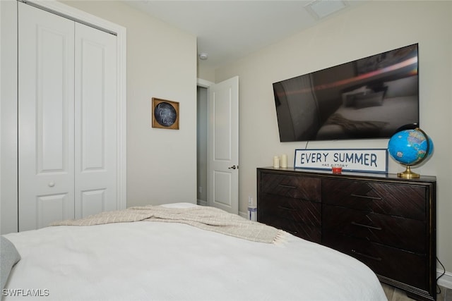 bedroom featuring a closet and visible vents