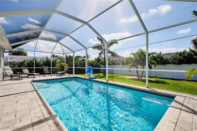 view of pool with a fenced in pool, a yard, a patio, a lanai, and a fenced backyard