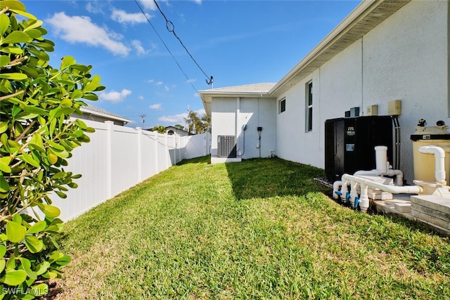 view of yard featuring a fenced backyard and central AC