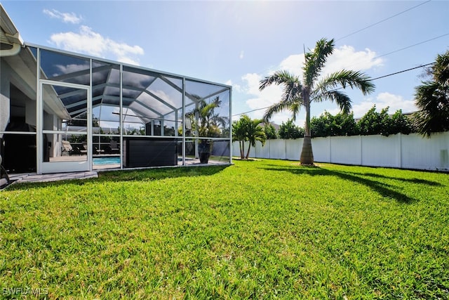 view of yard with fence private yard, glass enclosure, and an outdoor pool