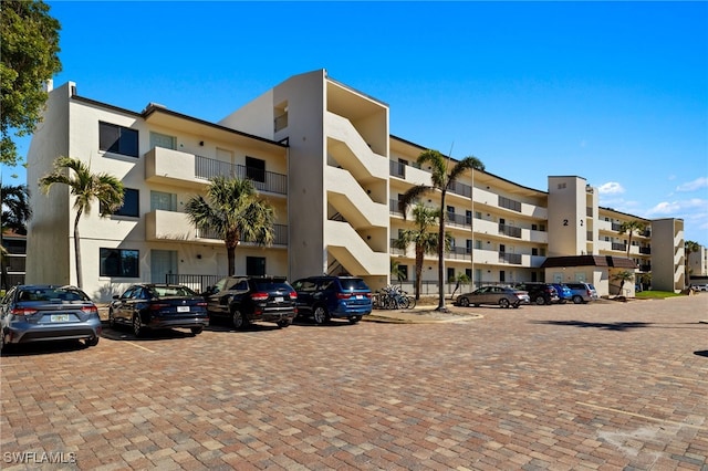 view of building exterior with uncovered parking