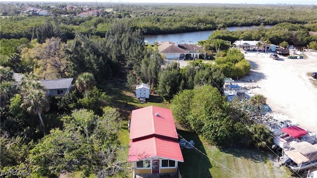 aerial view with a water view and a forest view