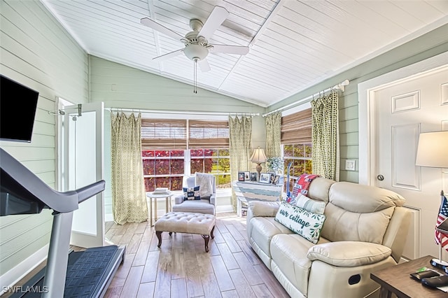 sunroom / solarium featuring lofted ceiling, wooden ceiling, and a ceiling fan