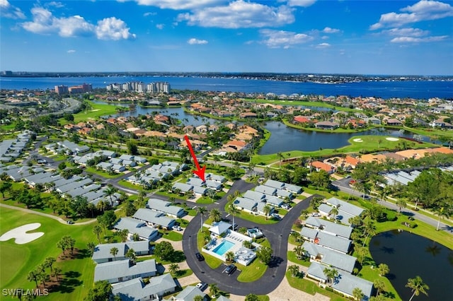 birds eye view of property with golf course view, a water view, and a residential view