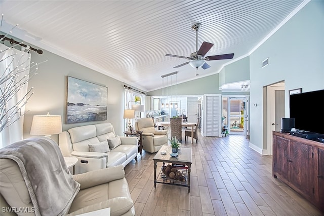 living area featuring ornamental molding, a healthy amount of sunlight, ceiling fan, and wood finished floors