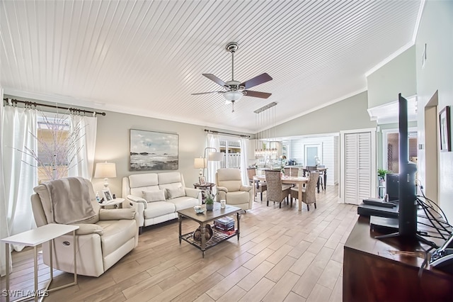 living room with a ceiling fan, vaulted ceiling, crown molding, and wood finished floors