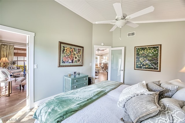 bedroom featuring high vaulted ceiling, ceiling fan, visible vents, and wood finished floors